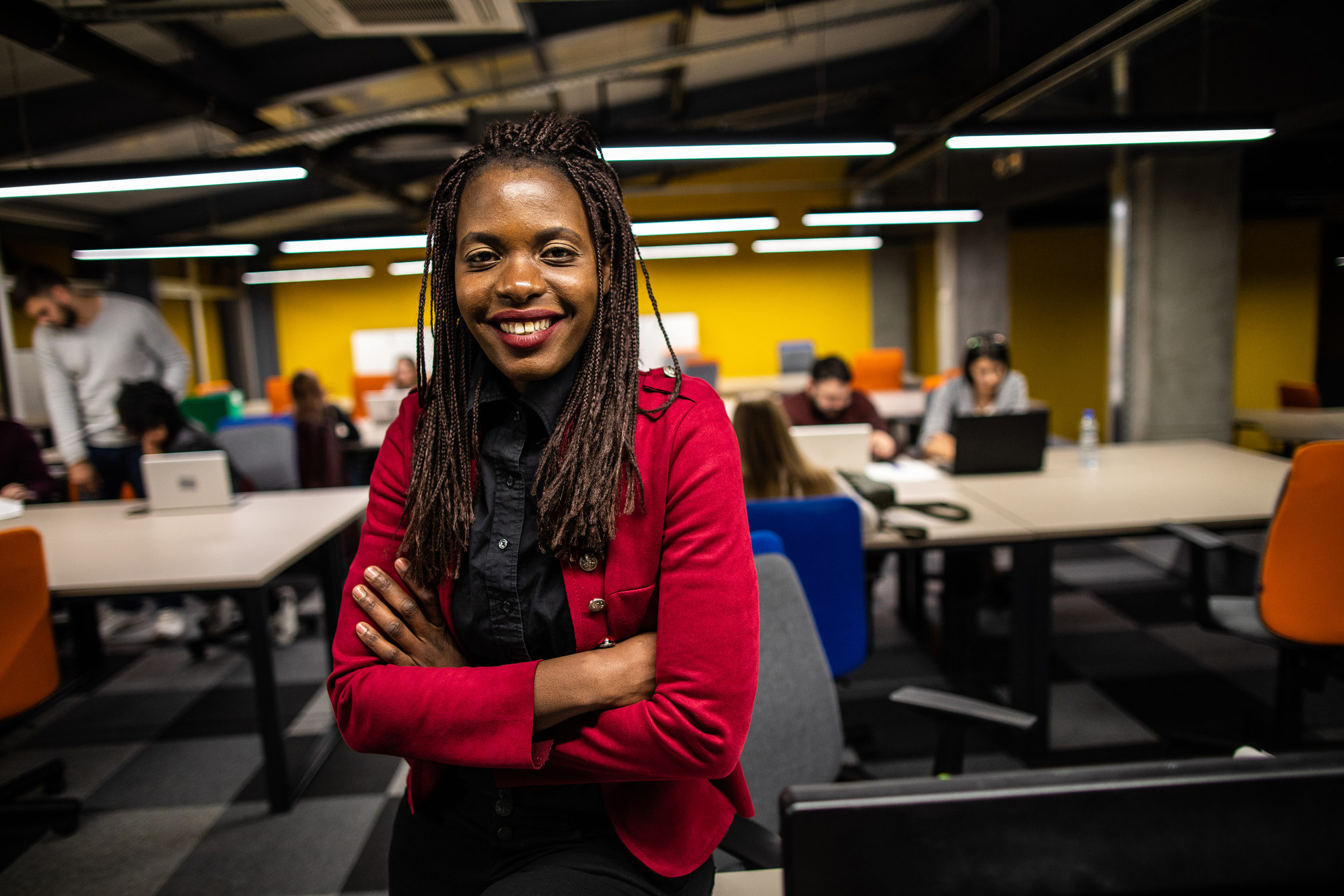 Happy African female entrepreneur at work